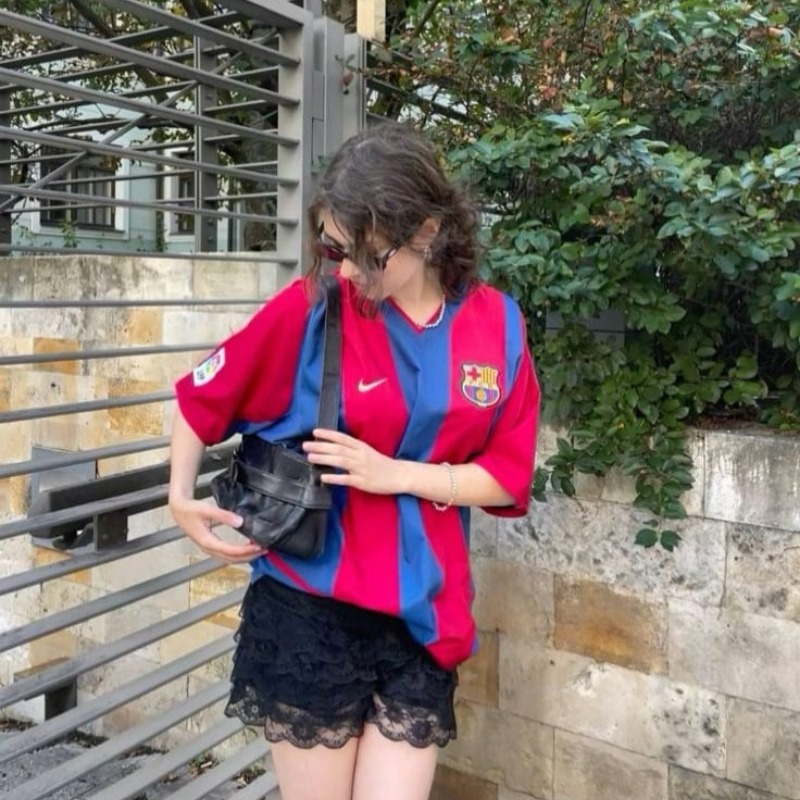 A girl wearing FC barcelona team jersey